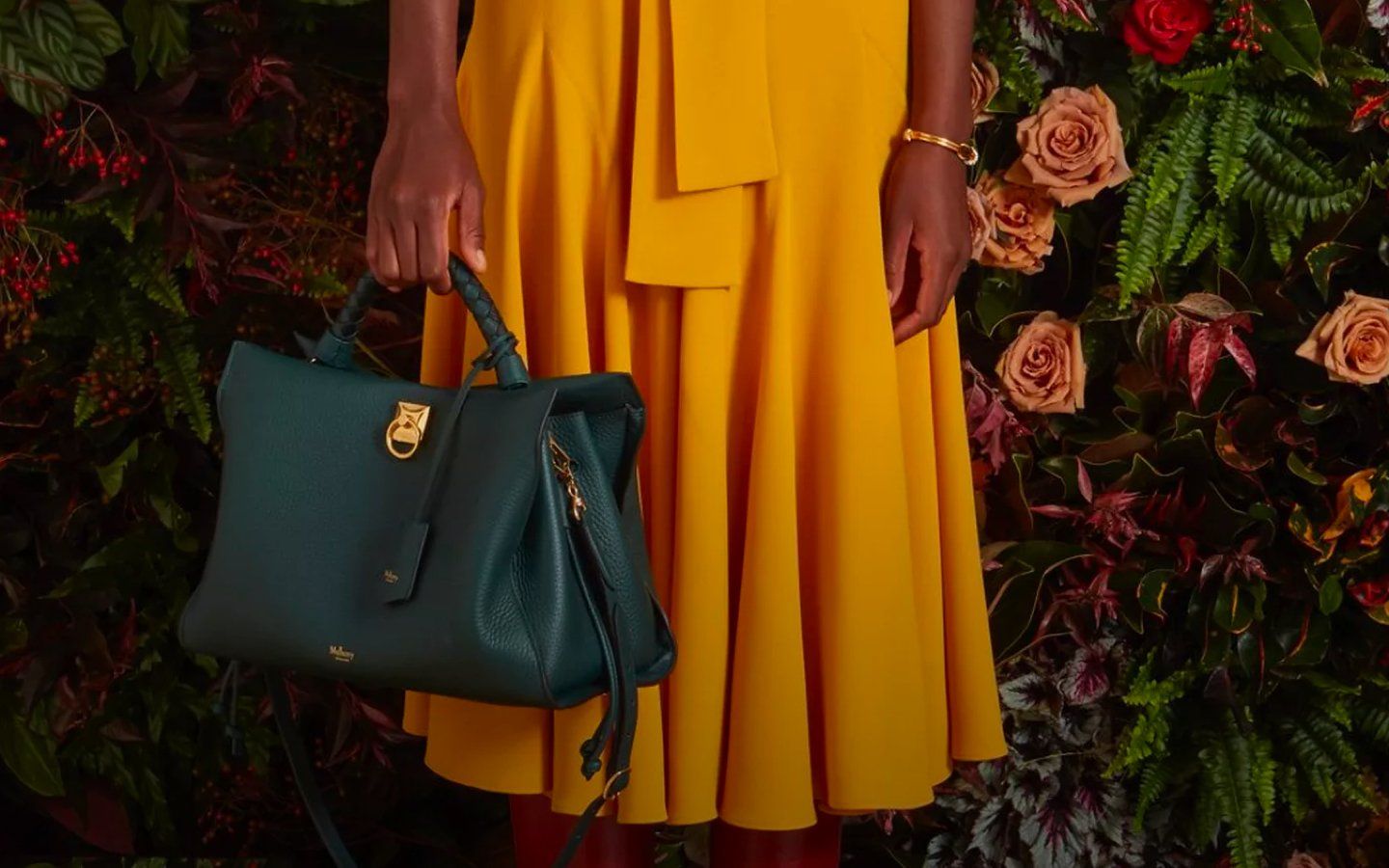 model holding mulberry iris bag in mulberry green